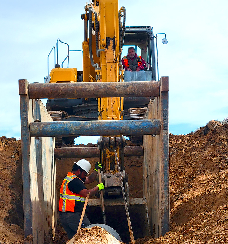 excavator placing drainage system